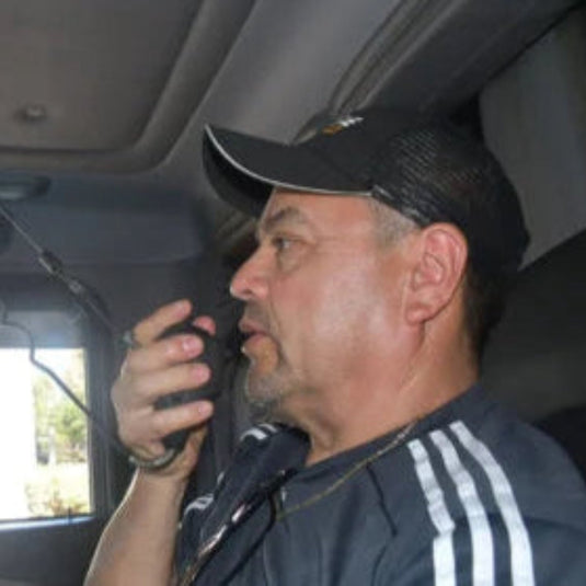 Man sitting inside a Truck using a CB Mic